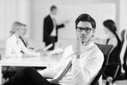 handsome young business man with colleagues in background